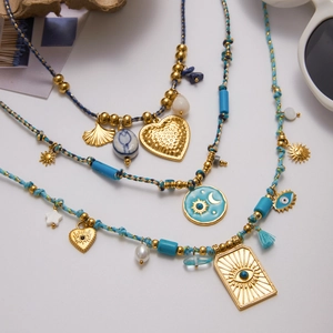 Bohemian multilayered gold necklace with blue beads, sun and moon charms, and heart pendant