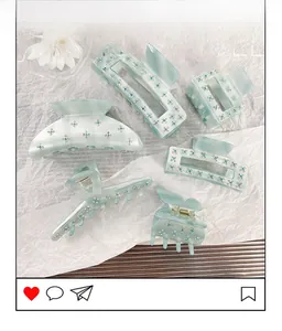 Detailed close-up of a 6-piece light blue acetate hair claw set with rhinestones and flowers