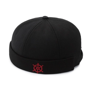 Retro black cotton docker hat featuring a detailed red helm embroidery on the front