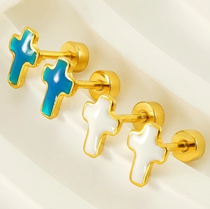Detail of cross screw back earrings in gold finish with blue and white enamel
