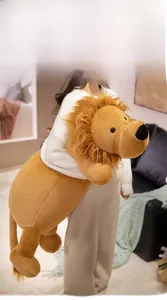 Soft plush lion toy held by a model to showcase the large size and fluffy texture