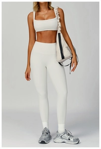 Detailed view of white ribbed yoga set featuring high waist leggings and U-neck sports bra