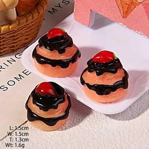 Macro detail of miniature resin strawberry chocolate cupcakes for DIY crafts and decor