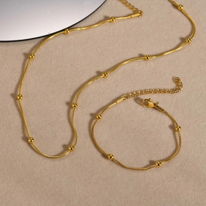 Elegant gold snake chain necklace and bracelet set with small round bead accents