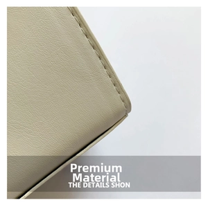 Close-up of the beige lychee pattern leather texture and neat stitching of the handbag