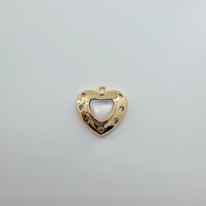 Detail of 18K gold-plated heart pendant with white shell inlay and sparkling crystals