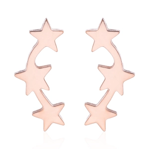 Close-up of rose gold star earrings with three connected pentagrams in a curve