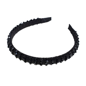 Retro style black beaded headband with faceted crystals on a minimal white background
