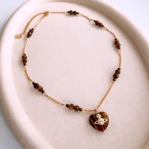 Vintage tiger eye heart pendant necklace with golden beaded chain and planet charm