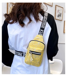 Detailed back view of yellow casual crossbody bag with printed strap on female model