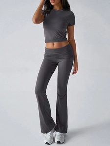 Close-up of dark grey yoga set with short sleeve crop top and flared leggings