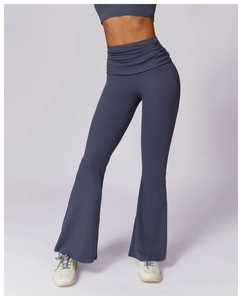 Close-up of high-waisted flare yoga pants in navy blue with ruched waist detail