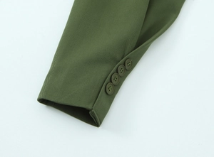 Dettaglio del polsino del blazer verde militare con quattro bottoni in resina e twill