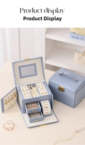 Three-layer blue jewelry organizer box showing inner velvet lining and drawer compartments