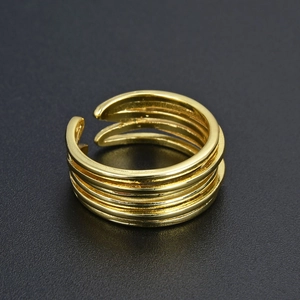 Detail of multi-layer gold ring with a polished finish on a professional black background