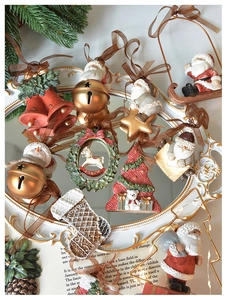 Detail of vintage Christmas resin charms including Santa, snowman and bells on a classic tray