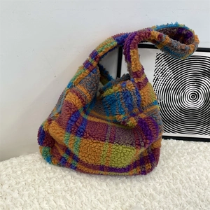 Close-up of fluffy multi-color plaid shoulder bag with vibrant wool-like texture
