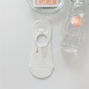 Detail of white cotton low-cut sock with delicate silver crescent moon embroidery