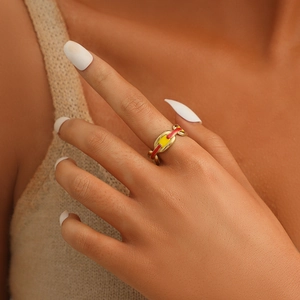 Detail of gold chain link ring with colorful red and yellow oil drip design on model