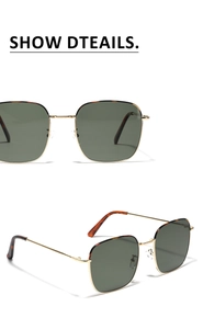 Detailed close-up of dark green square sunglasses with golden metal frame and tortoise temples