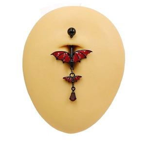 Gothic black bat belly button ring with red teardrop pendant on a silicone model