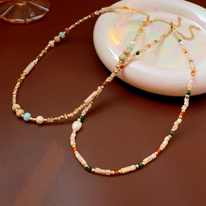 Detailed close-up of baroque freshwater pearl necklaces with colorful beaded textures