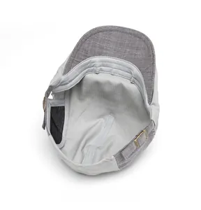 Detail view of newsboy cap interior featuring grey lining and metal side buckle adjustment
