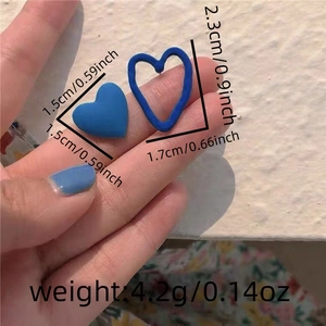 Detail showing asymmetrical blue heart earrings with size measurements and 4.2g weight