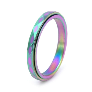 Macro view of colorful stainless steel spinning ring with textured hammered finish details