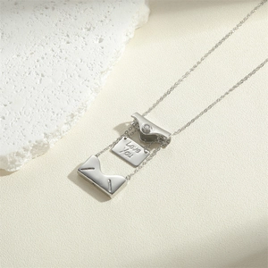Silver envelope necklace with Love You engraving on removable plate over white stones