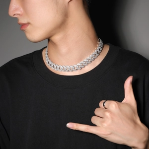 Close-up of 20mm silver Cuban link necklace with sparkling cubic zirconia on a male model