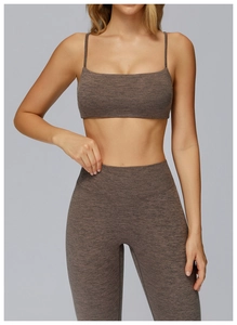 Detail view of heathered brown seamless yoga set with thin straps and high waist pants
