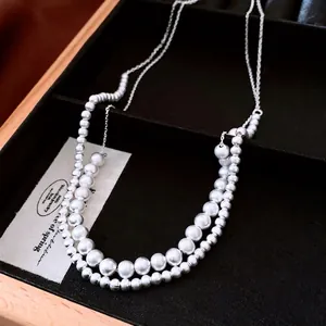 French palace style double-layered pearl necklace with gradient beads on a velvet tray