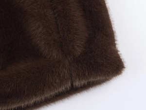 Detailed macro shot of dark brown faux fur texture with dense high-quality fibers