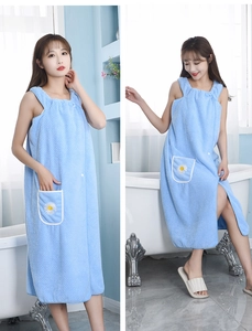 Detailed view of light blue wearable bath towel dress with white daisy embroidery pocket