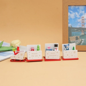Close-up of a 4-car wooden Christmas train with Santa and festive holiday gift details