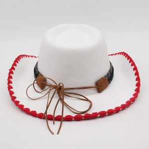 Detail of white felt cowboy hat featuring red stitched edges and ethnic patterned ribbon