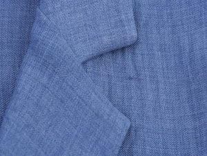 Detailed macro shot showing the elegant blue cotton linen fabric texture and stitching