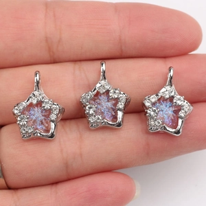 Set of three star-shaped alloy pendants with zircon inlay and iridescent purple centers