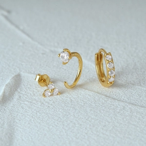 Detail shot of three-piece gold S925 sterling silver earrings with clear cubic zirconia
