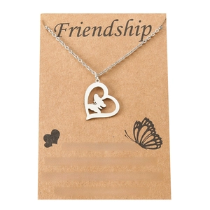Stainless steel heart and butterfly friendship necklace on a rustic gift display card