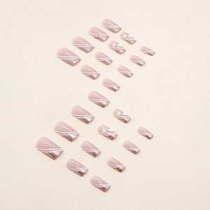 Pink gradient press-on nails with glitter French tips, white swirls and heart designs