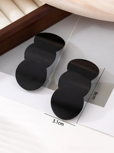 Detail of 3.1cm black circular earring discs with fine horizontal brushed metal texture