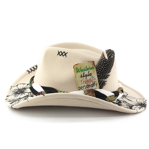 Detail of beige felt cowboy hat with ribbon, feather, and Western style vintage label
