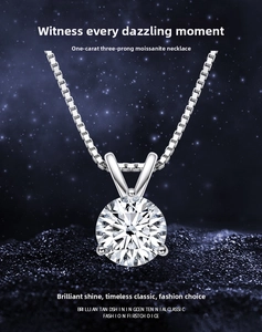 Detailed macro shot of 1 carat moissanite pendant with three-prong setting and box chain