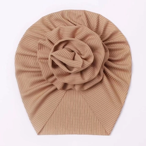 Detail of ribbed knit baby turban hat in light khaki with large fabric rose flower