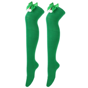 Detail of green over-knee socks with silk bows and white plush pom-poms for holidays