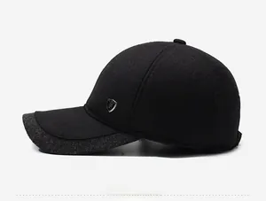 Detailed side view of black wool baseball cap with grey brim edge and metal logo