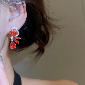 Detail view of elegant red butterfly zircon tassel earrings on model with silver base