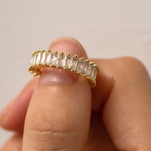 Close-up of 18k gold plated ring featuring sparkling baguette-cut cubic zirconia crystals